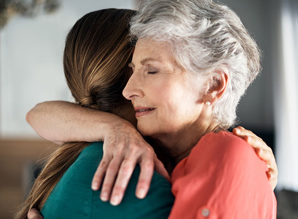 older woman hug younger woman